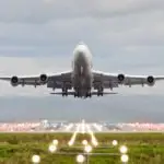 Airplane taking off from Manchester Airport representing income, cost and capacity modelling forecasting